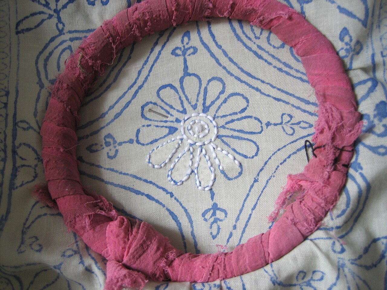 Embroidered chikankari garments hang in a Lucknow shop.